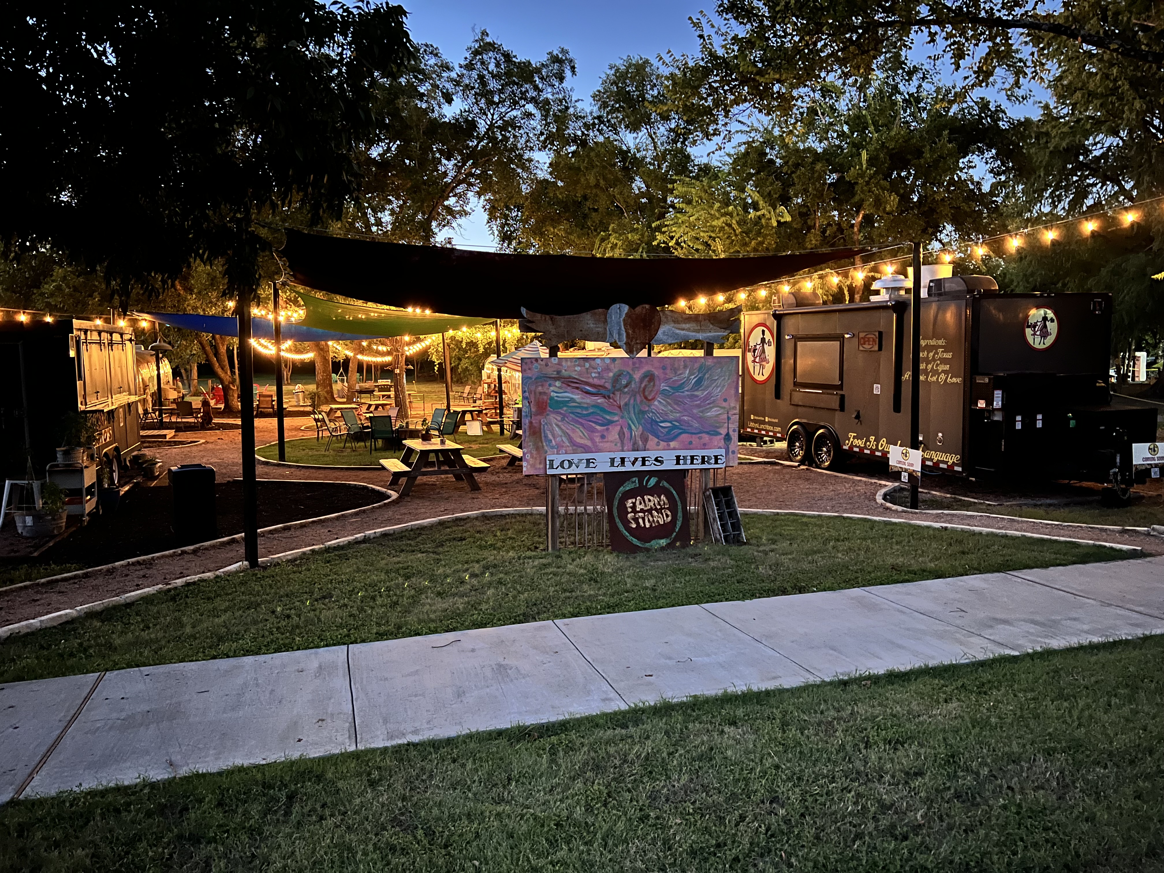 Food truck with rainbow behind it.